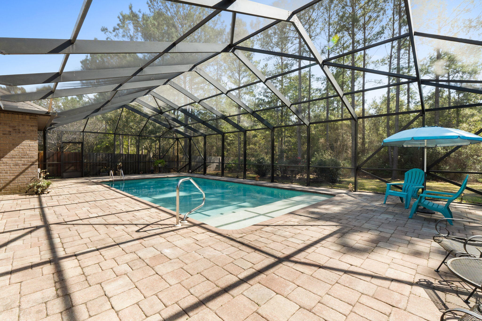 67 Secret Street Freeport, FL 32439 - Photo 51 of 63 a view of backyard with a table and chairs under an umbrella