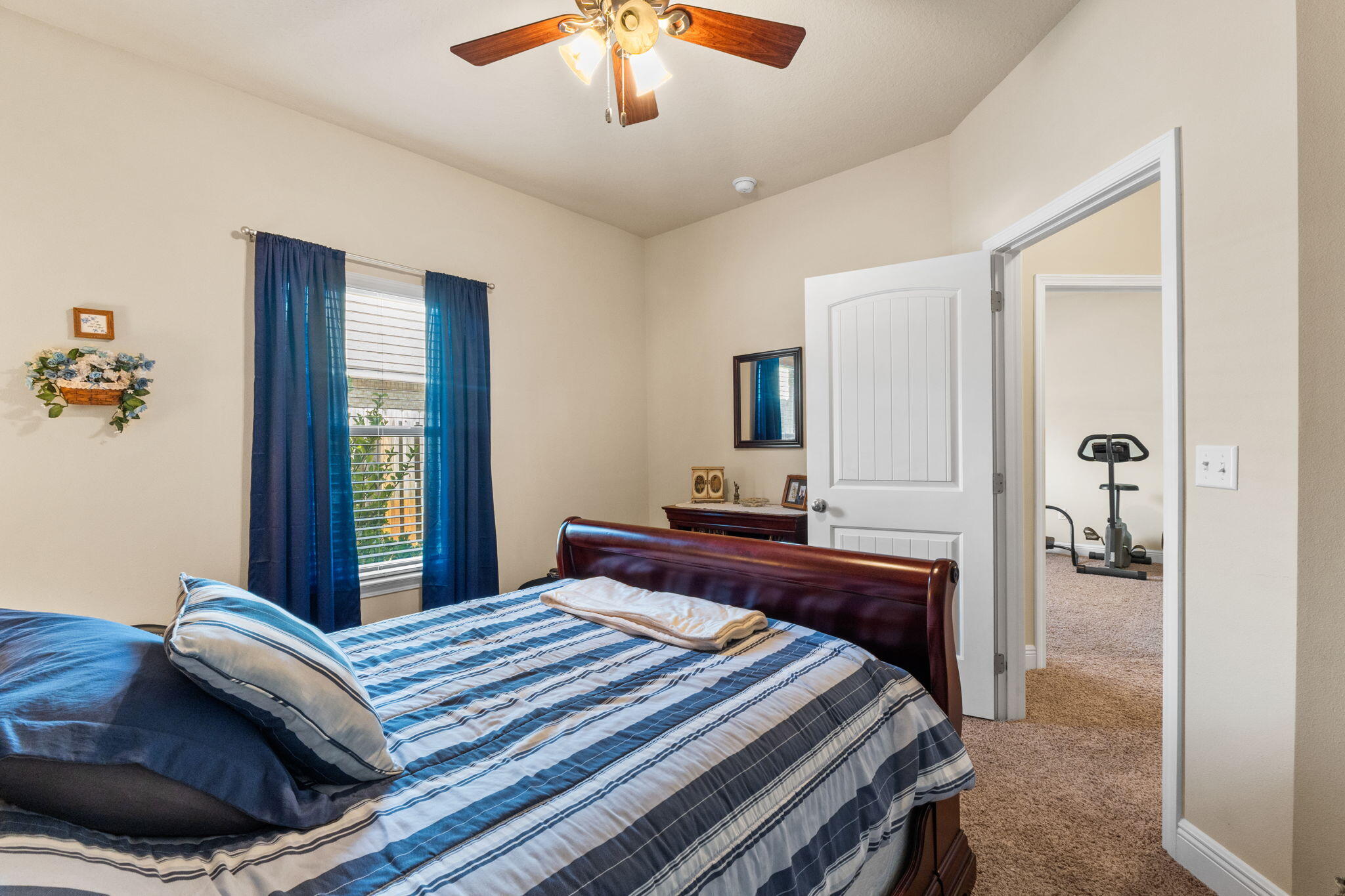 67 Secret Street Freeport, FL 32439 - Photo 62 of 63 a bedroom with a bed and a chandelier