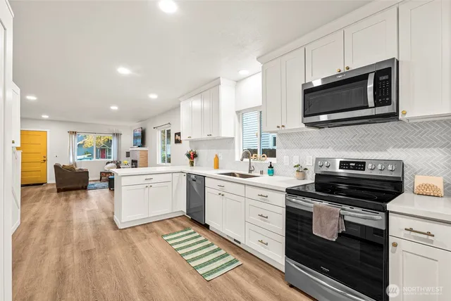 a kitchen with a sink stove and microwave