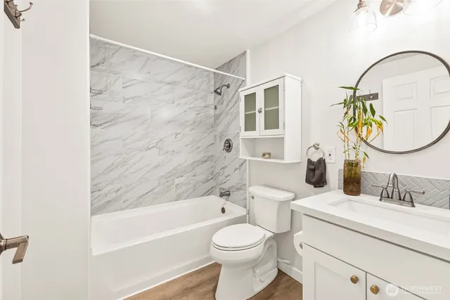 a bathroom with a sink mirror toilet and bathtub