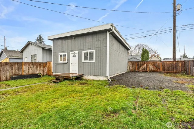 a backyard of a house with table and chairs