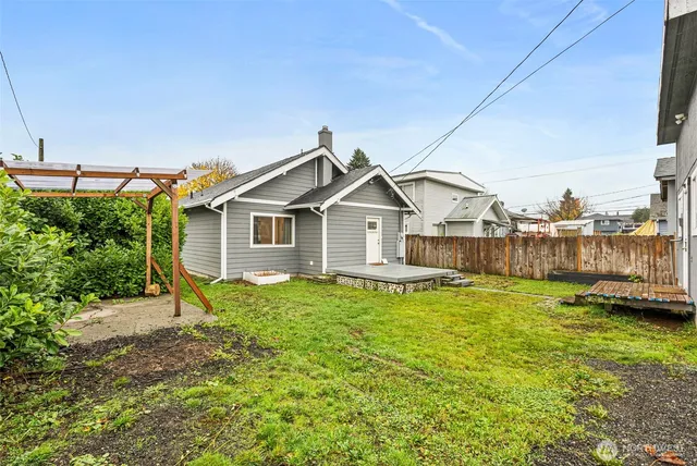a view of a house with a yard and sitting area