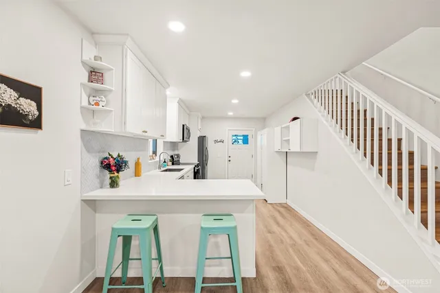 a view of kitchen center island and wooden floor