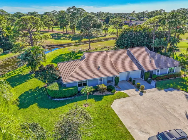 an aerial view of a house with a yard table and chairs
