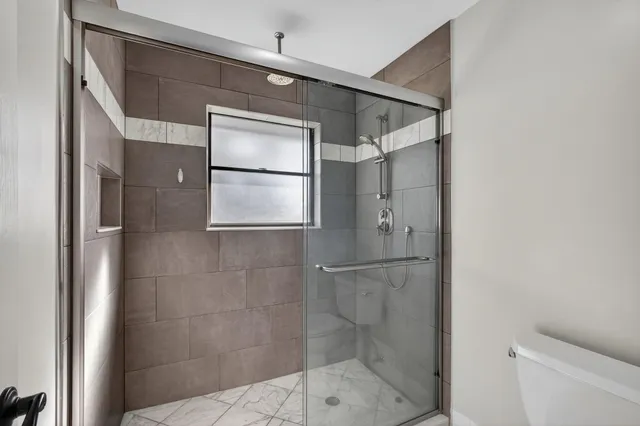 a bathroom with a glass shower door
