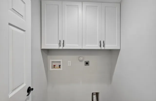 a view of a house with potted plants and a table