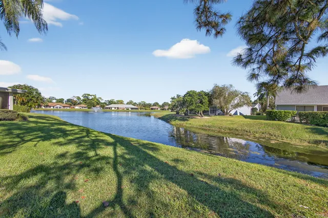 an aerial view of residential houses with outdoor space and swimming pool