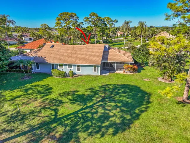 a view of house with a backyard