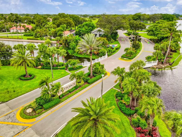 an aerial view of residential houses with outdoor space and ocean view