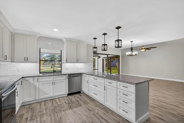 a kitchen with cabinets a sink and appliances