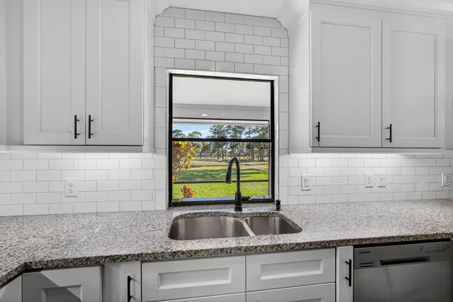 a kitchen with sink and window