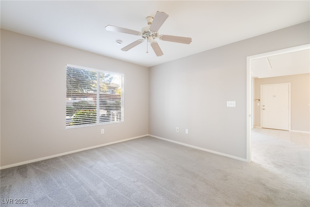 8070 West Russell Road, Unit 1022 Las Vegas, NV 89113 - Photo 17 of 32 Empty room with light carpet, attic access, and a ceiling fan