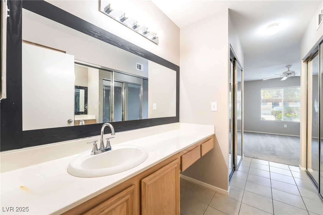 8070 West Russell Road, Unit 1022 Las Vegas, NV 89113 - Photo 22 of 32 Bathroom with vanity, light tile patterned flooring, ceiling fan, and light colored carpet