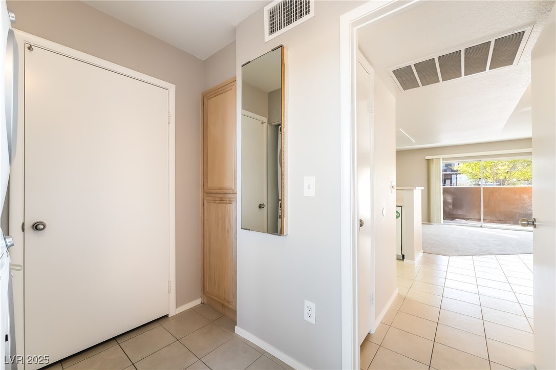 8070 West Russell Road, Unit 1022 Las Vegas, NV 89113 - Photo 29 of 32 Hallway with light tile patterned flooring and baseboards