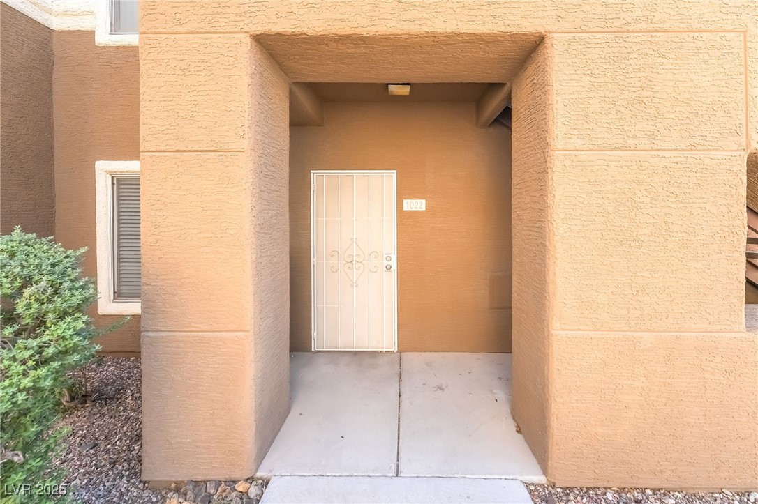 8070 West Russell Road, Unit 1022 Las Vegas, NV 89113 - Photo 4 of 32 View of exterior entry with stucco siding