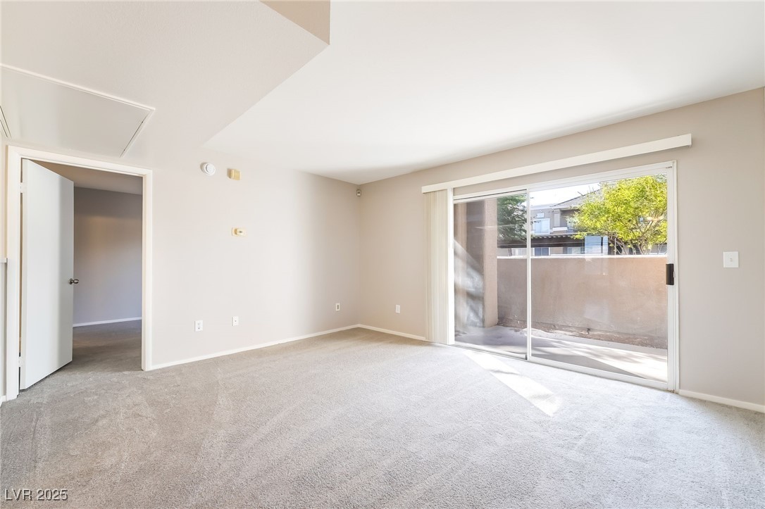 8070 West Russell Road, Unit 1022 Las Vegas, NV 89113 - Photo 5 of 32 Unfurnished bedroom featuring carpet flooring and access to outside