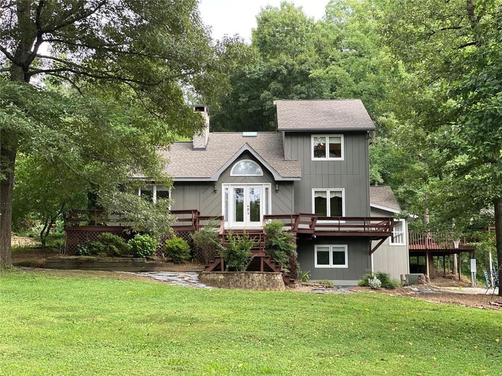 719 Mt Zion Road Northeast Resaca, GA 30735 - Photo 1 of 1 a front view of a house with a garden and trees