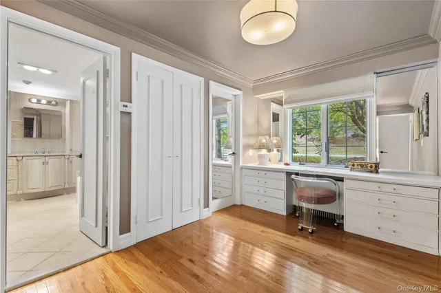 a view of a workspace with furniture and a window