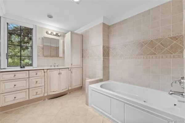 a bathroom with a granite countertop sink a toilet and bathtub