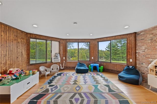 a bedroom with furniture and a large window