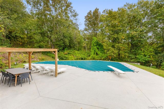 a view of swimming pool with a patio