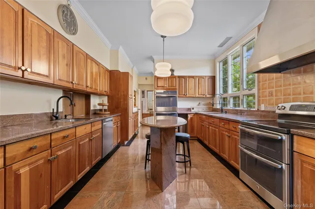 a kitchen with stainless steel appliances granite countertop a sink stove and cabinets