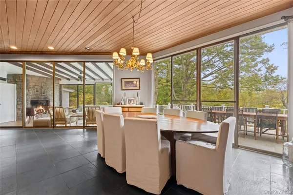a view of a dining room with furniture large windows and wooden floor