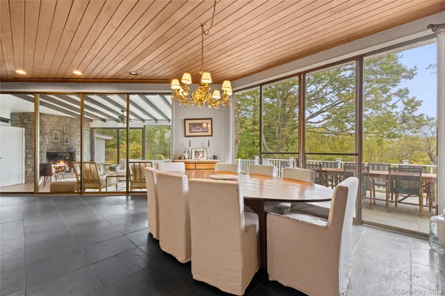 a view of a dining room with furniture large windows and wooden floor