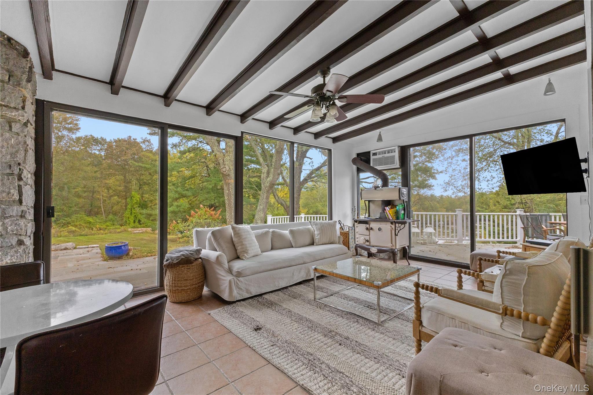 898 Gipsy Trail Road Carmel, NY 10512 - Photo 9 of 42 a living room with furniture tv and large windows