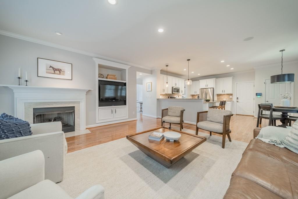 7604 Birchwalk Drive Huntersville, NC 28078 - Photo 11 of 37 a living room with furniture a flat screen tv and a fireplace