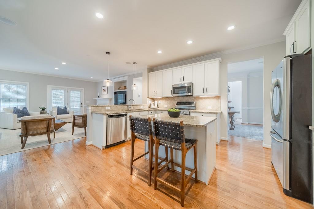 7604 Birchwalk Drive Huntersville, NC 28078 - Photo 14 of 37 a kitchen with stainless steel appliances kitchen island granite countertop a refrigerator and a stove top oven