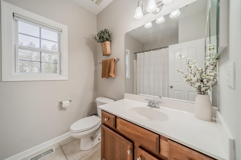 7604 Birchwalk Drive Huntersville, NC 28078 - Photo 19 of 37 a bathroom with a sink vanity granite and toilet
