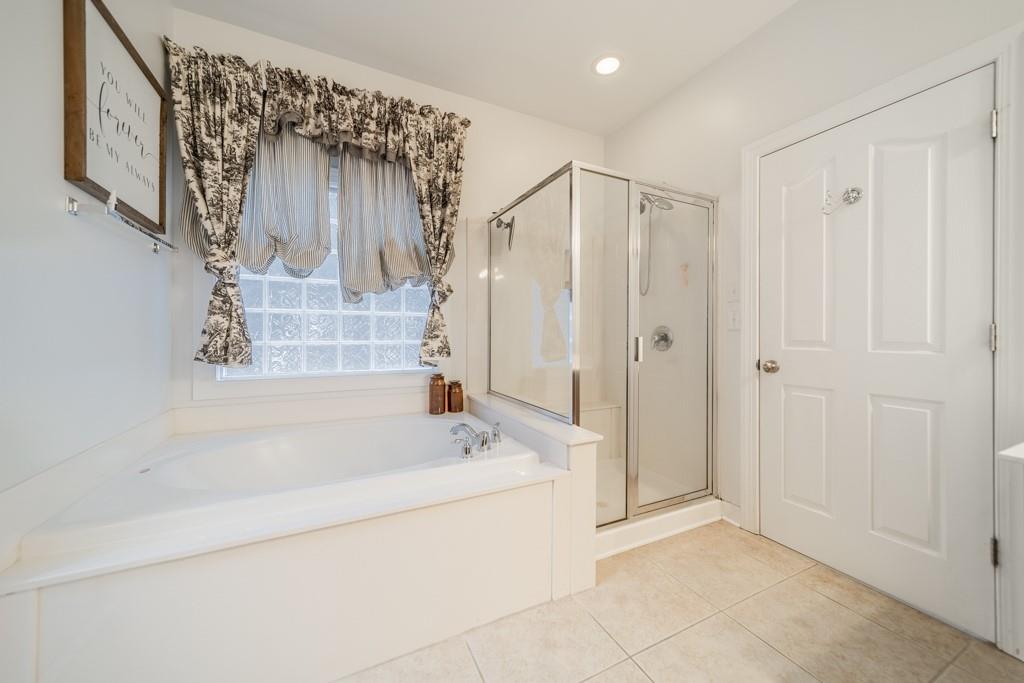7604 Birchwalk Drive Huntersville, NC 28078 - Photo 25 of 37 a bathroom with a bathtub a shower and a sink