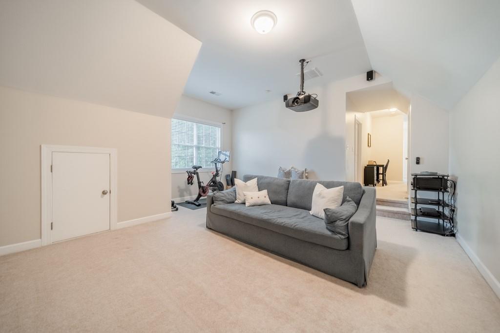 7604 Birchwalk Drive Huntersville, NC 28078 - Photo 27 of 37 a living room with furniture a chandelier and a window