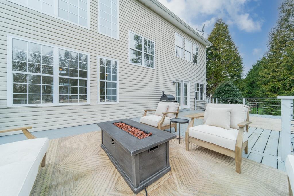 7604 Birchwalk Drive Huntersville, NC 28078 - Photo 28 of 37 a roof deck with couches and wooden floor
