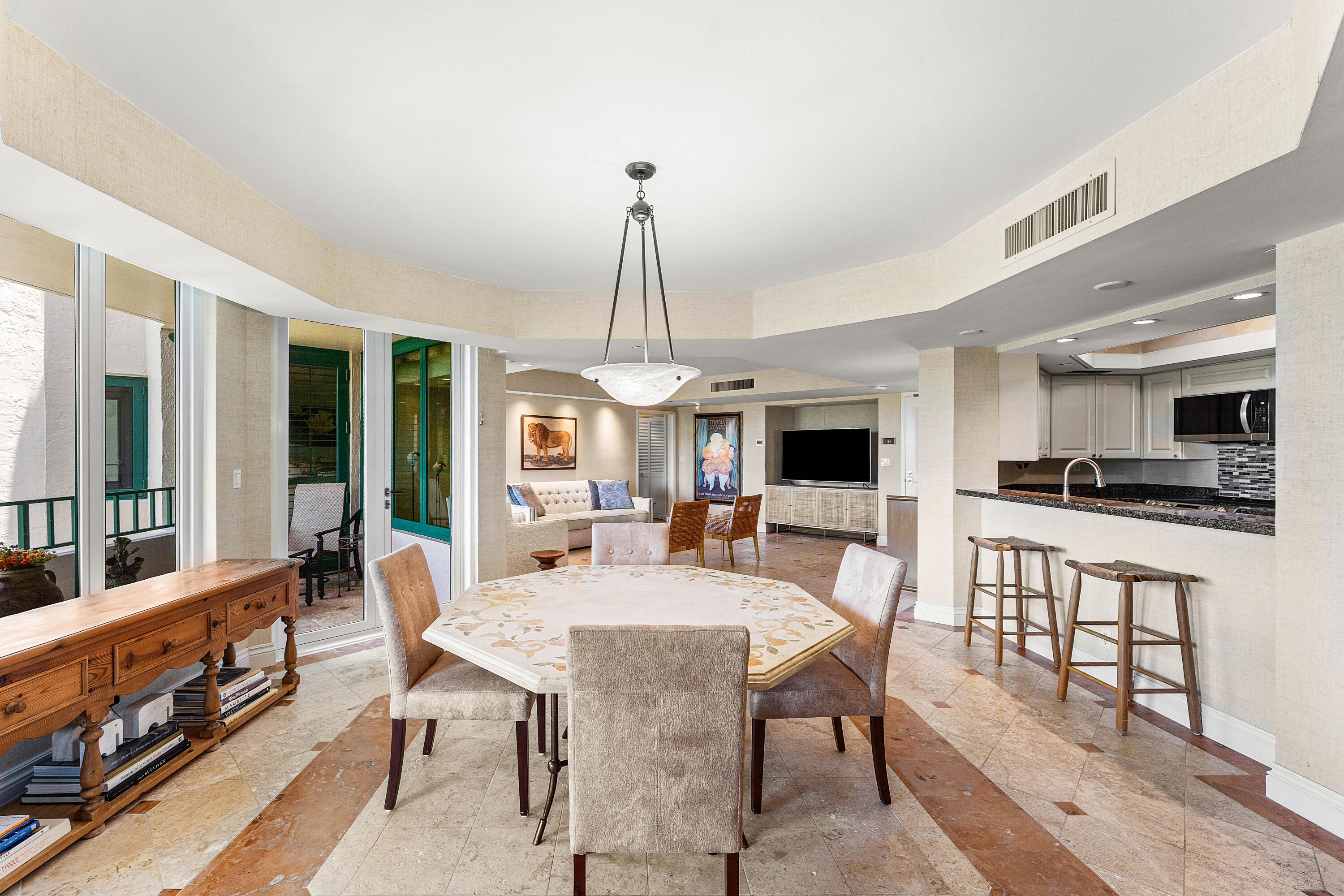 100 Southeast 5th Avenue, Unit 410 Boca Raton, FL 33432 - Photo 12 of 63 a view of a dining room with furniture window and wooden floor