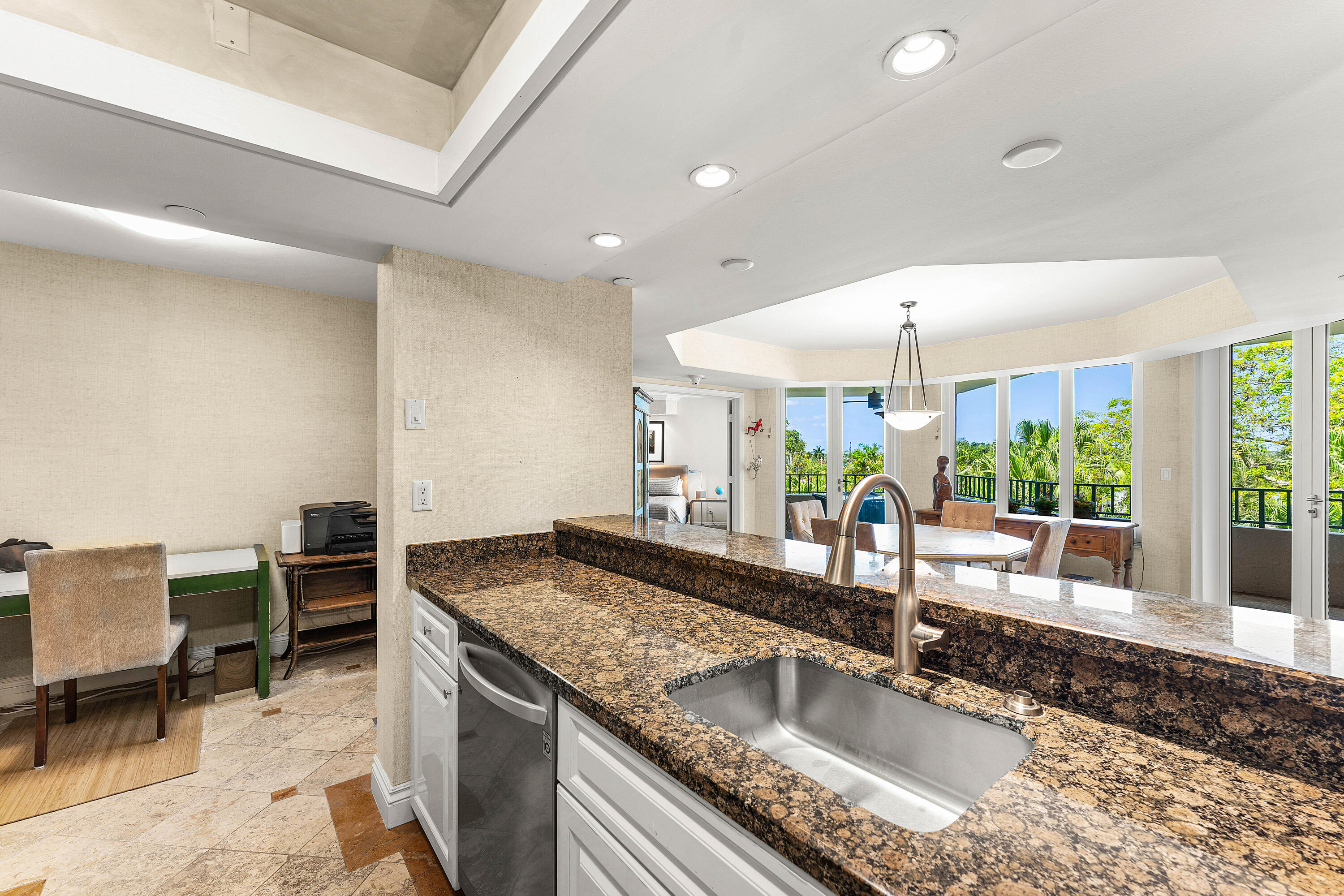 100 Southeast 5th Avenue, Unit 410 Boca Raton, FL 33432 - Photo 16 of 63 a kitchen with granite countertop a sink and a stove