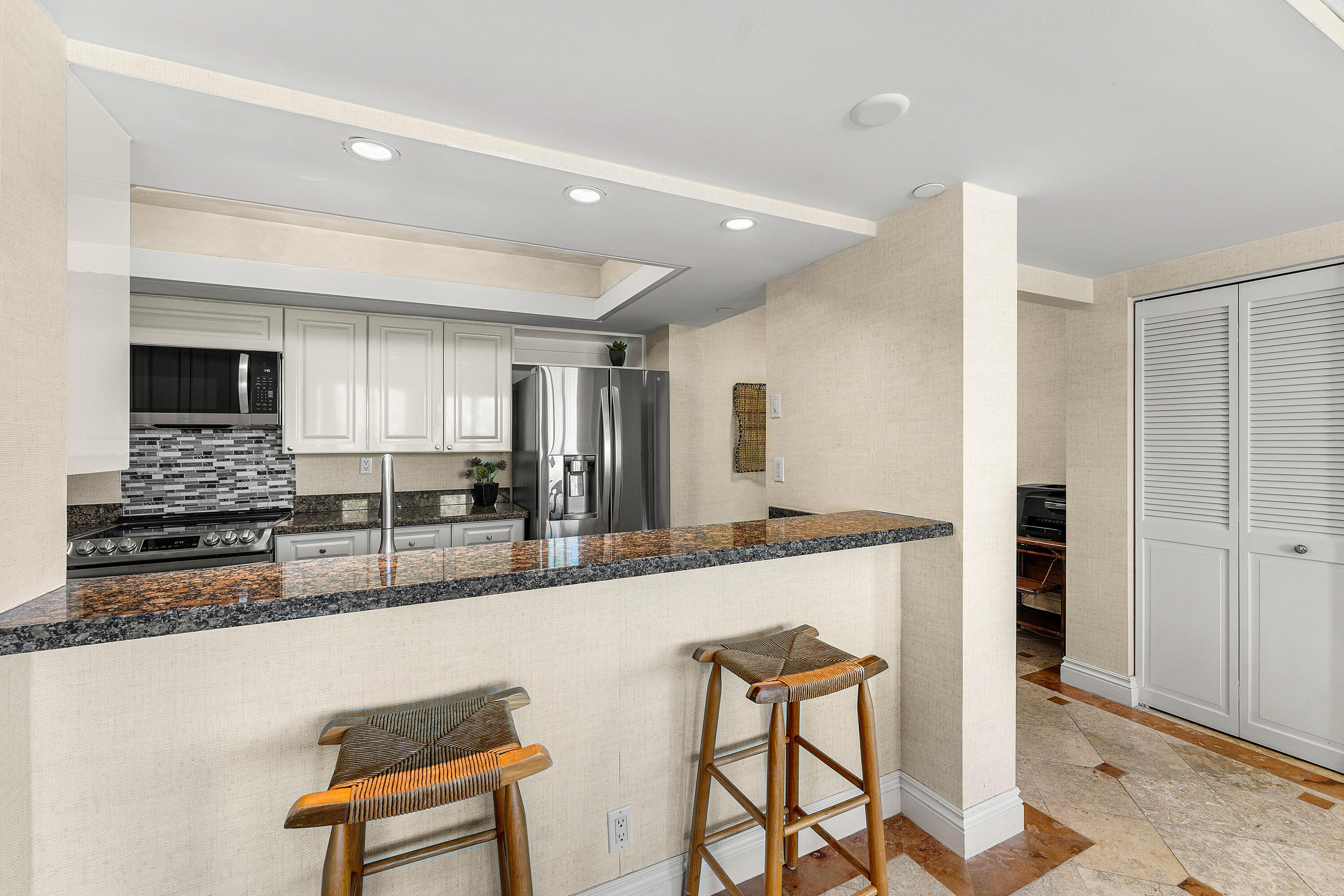 100 Southeast 5th Avenue, Unit 410 Boca Raton, FL 33432 - Photo 17 of 63 a large kitchen with granite countertop a large counter top space a sink stainless steel appliances and cabinets