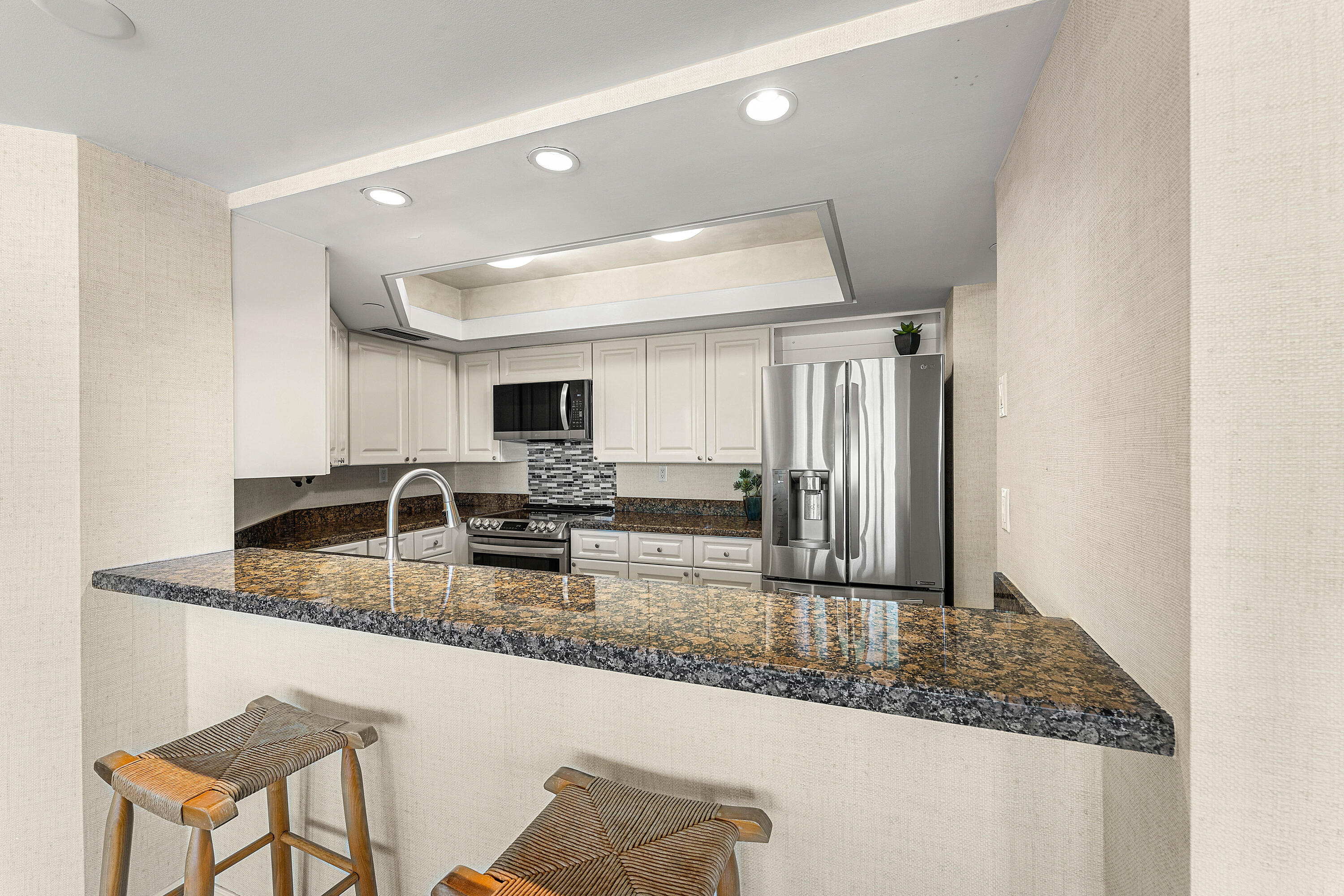 100 Southeast 5th Avenue, Unit 410 Boca Raton, FL 33432 - Photo 19 of 63 a kitchen with stainless steel appliances granite countertop a sink refrigerator and cabinets