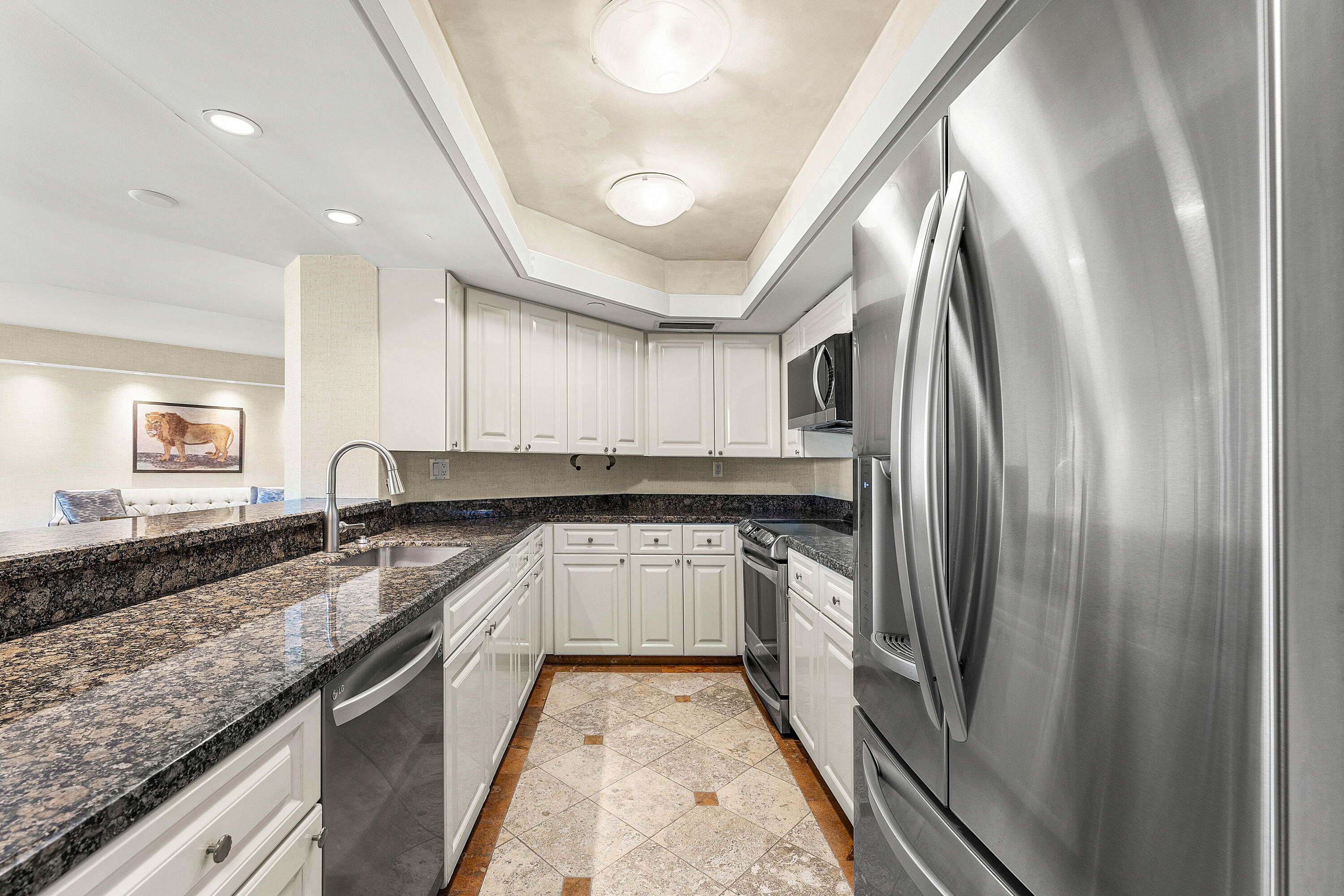 100 Southeast 5th Avenue, Unit 410 Boca Raton, FL 33432 - Photo 20 of 63 a kitchen with stainless steel appliances granite countertop a sink and a refrigerator