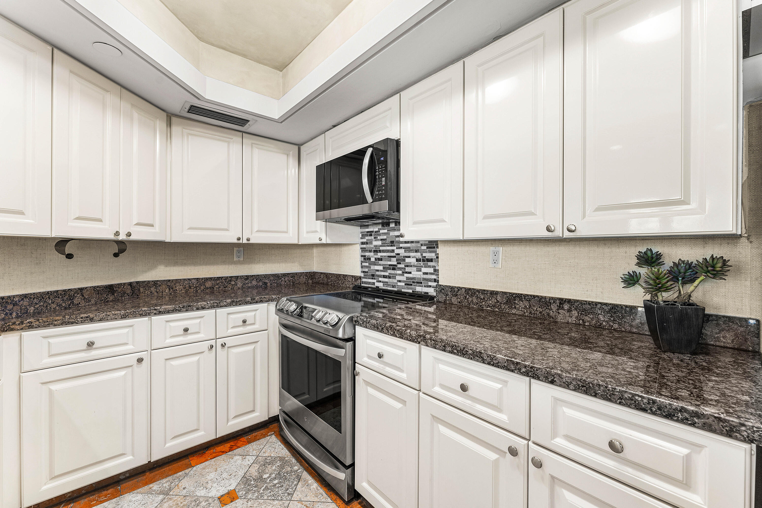 100 Southeast 5th Avenue, Unit 410 Boca Raton, FL 33432 - Photo 21 of 63 a kitchen with stainless steel appliances granite countertop a sink a stove and cabinets
