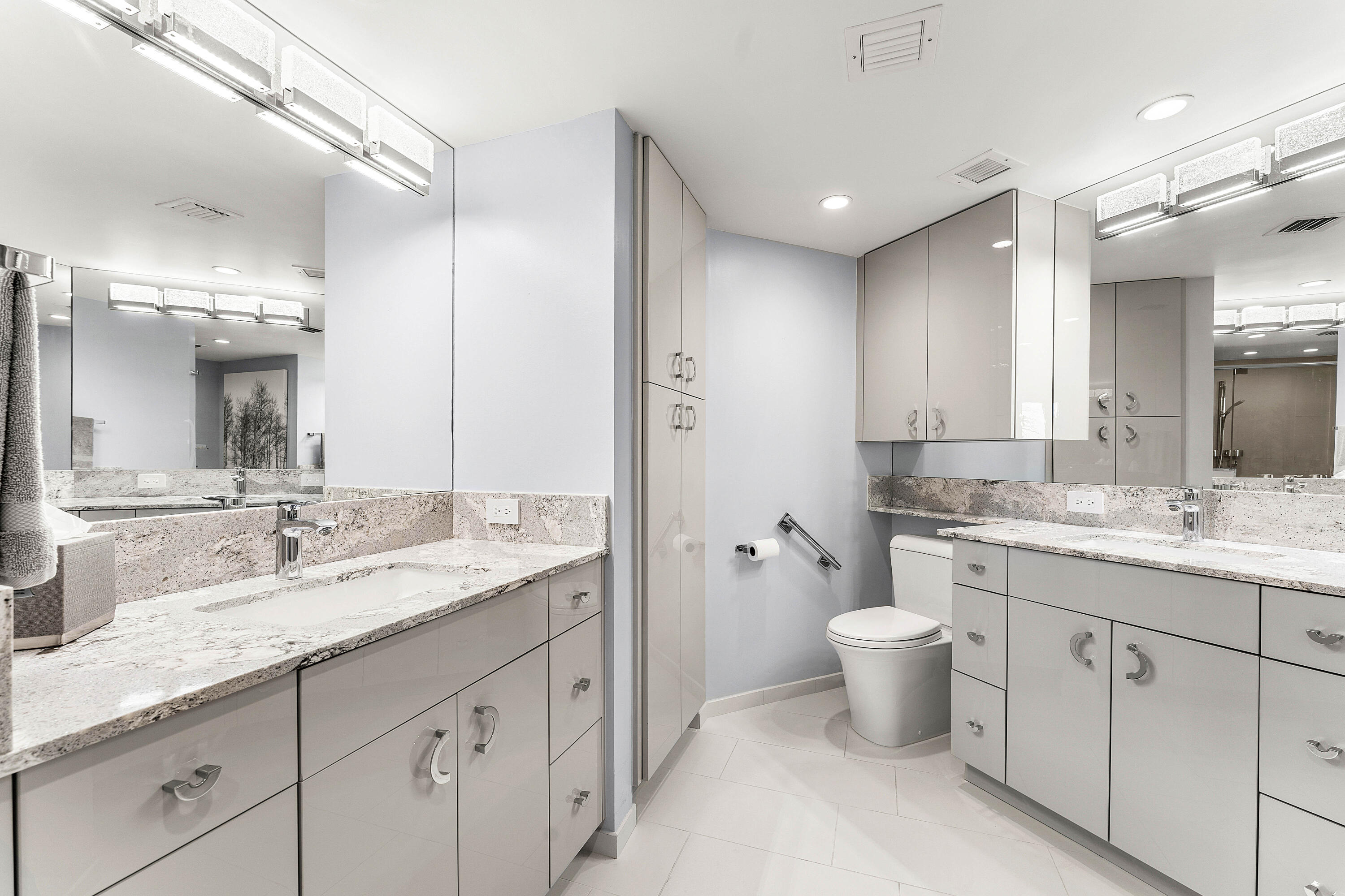 100 Southeast 5th Avenue, Unit 410 Boca Raton, FL 33432 - Photo 29 of 63 a bathroom with a granite countertop double vanity sink a mirror and a toilet
