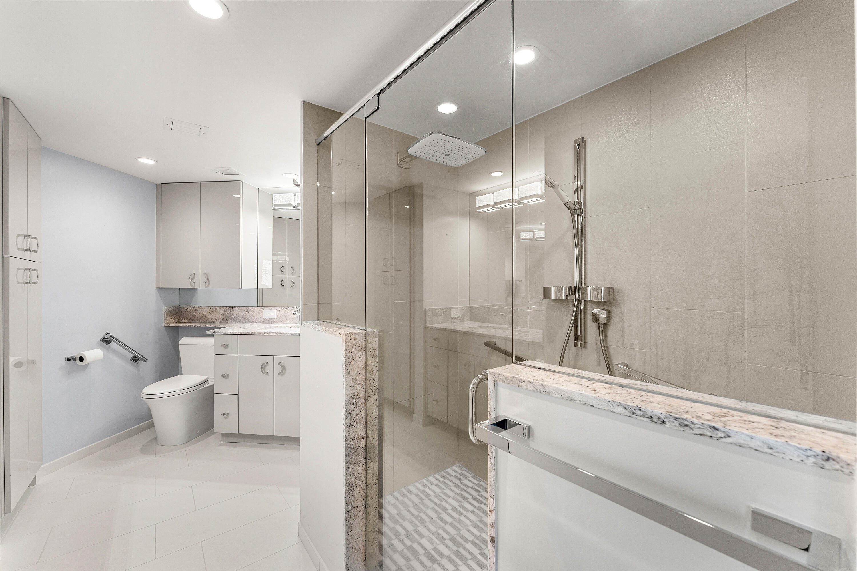 100 Southeast 5th Avenue, Unit 410 Boca Raton, FL 33432 - Photo 30 of 63 a bathroom with a sink a toilet a mirror and shower