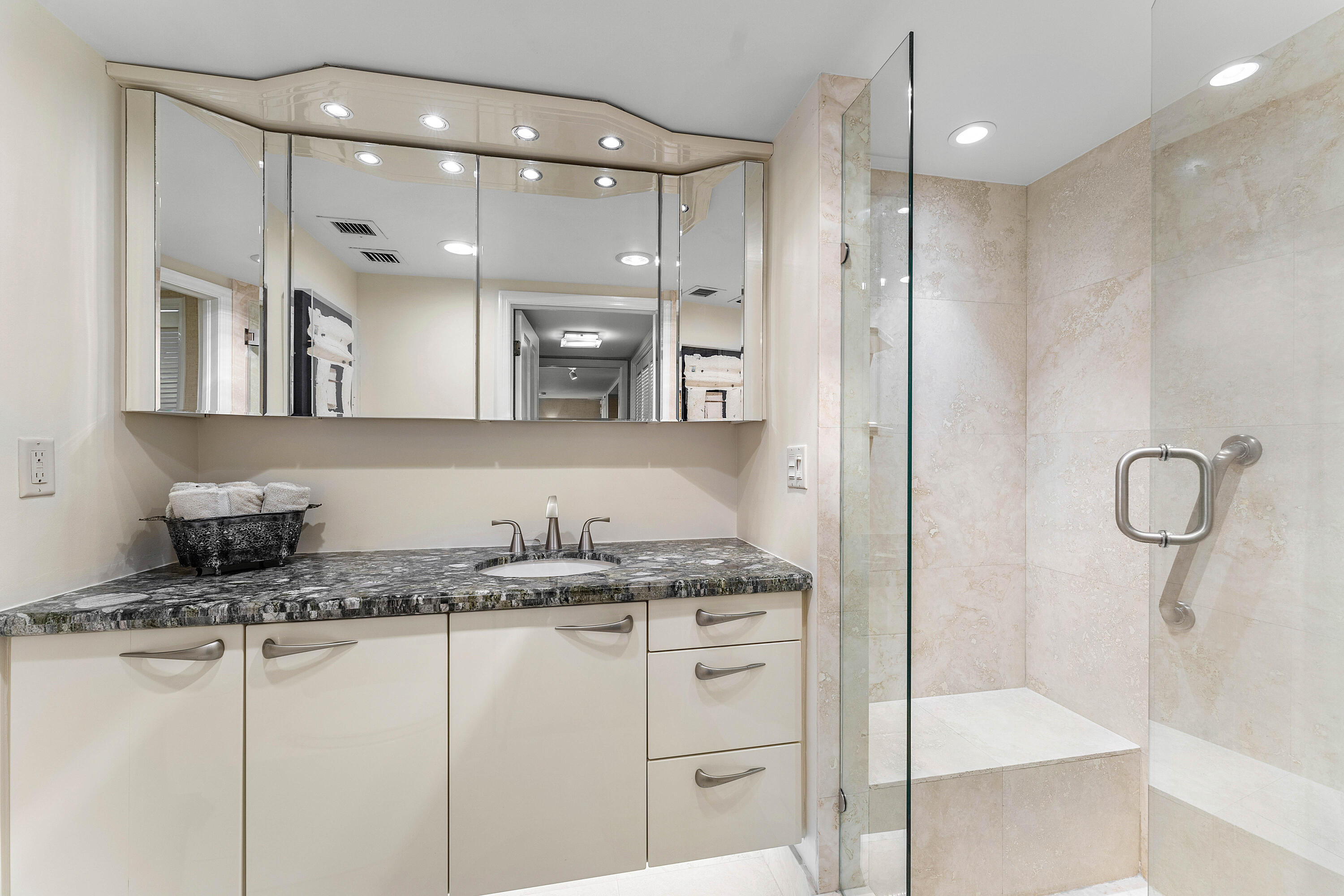 100 Southeast 5th Avenue, Unit 410 Boca Raton, FL 33432 - Photo 34 of 63 a bathroom with a granite countertop sink a mirror and shower