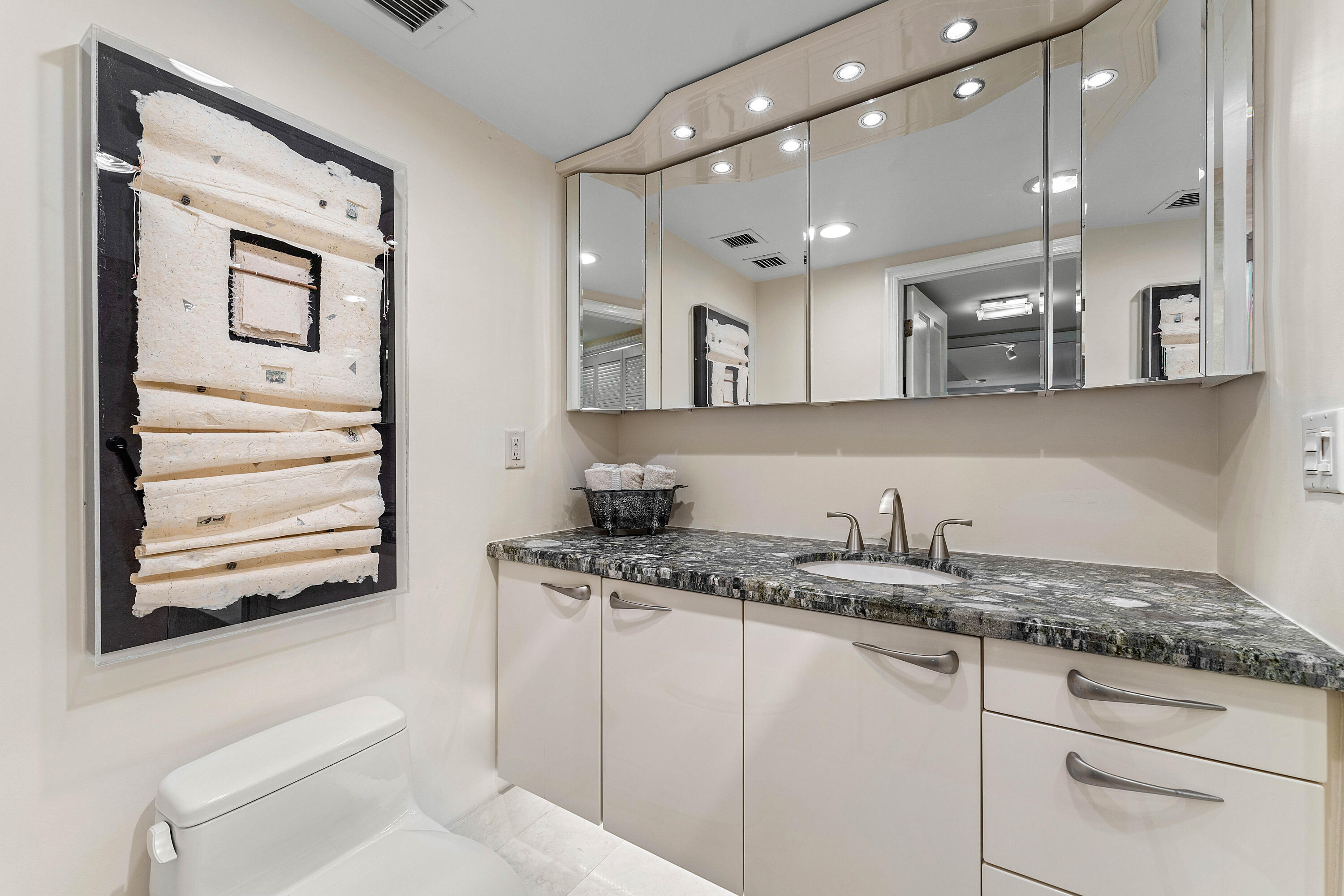 100 Southeast 5th Avenue, Unit 410 Boca Raton, FL 33432 - Photo 35 of 63 a bathroom with a granite countertop sink mirror vanity and toilet
