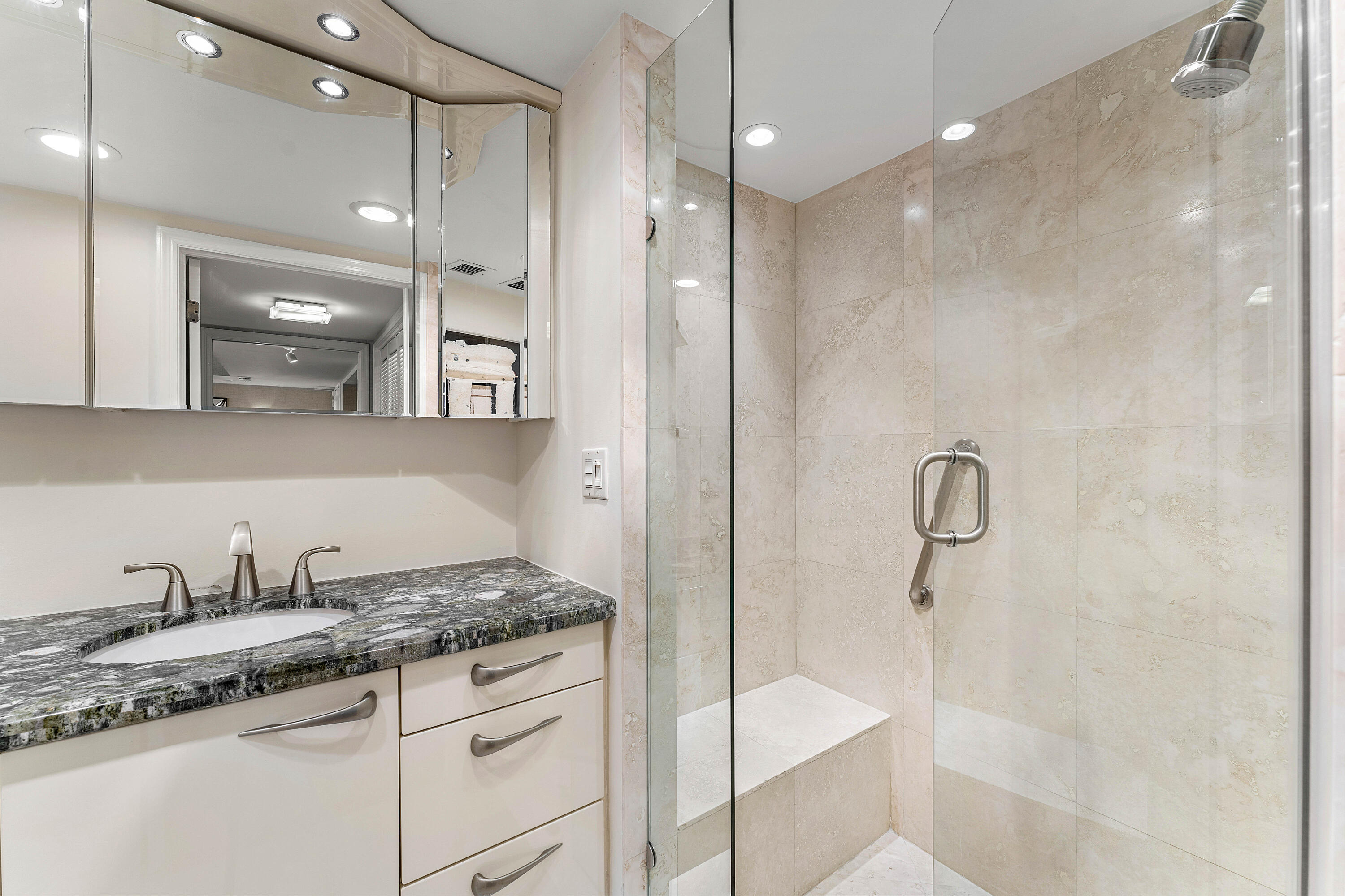 100 Southeast 5th Avenue, Unit 410 Boca Raton, FL 33432 - Photo 36 of 63 a bathroom with a granite countertop sink a mirror and shower