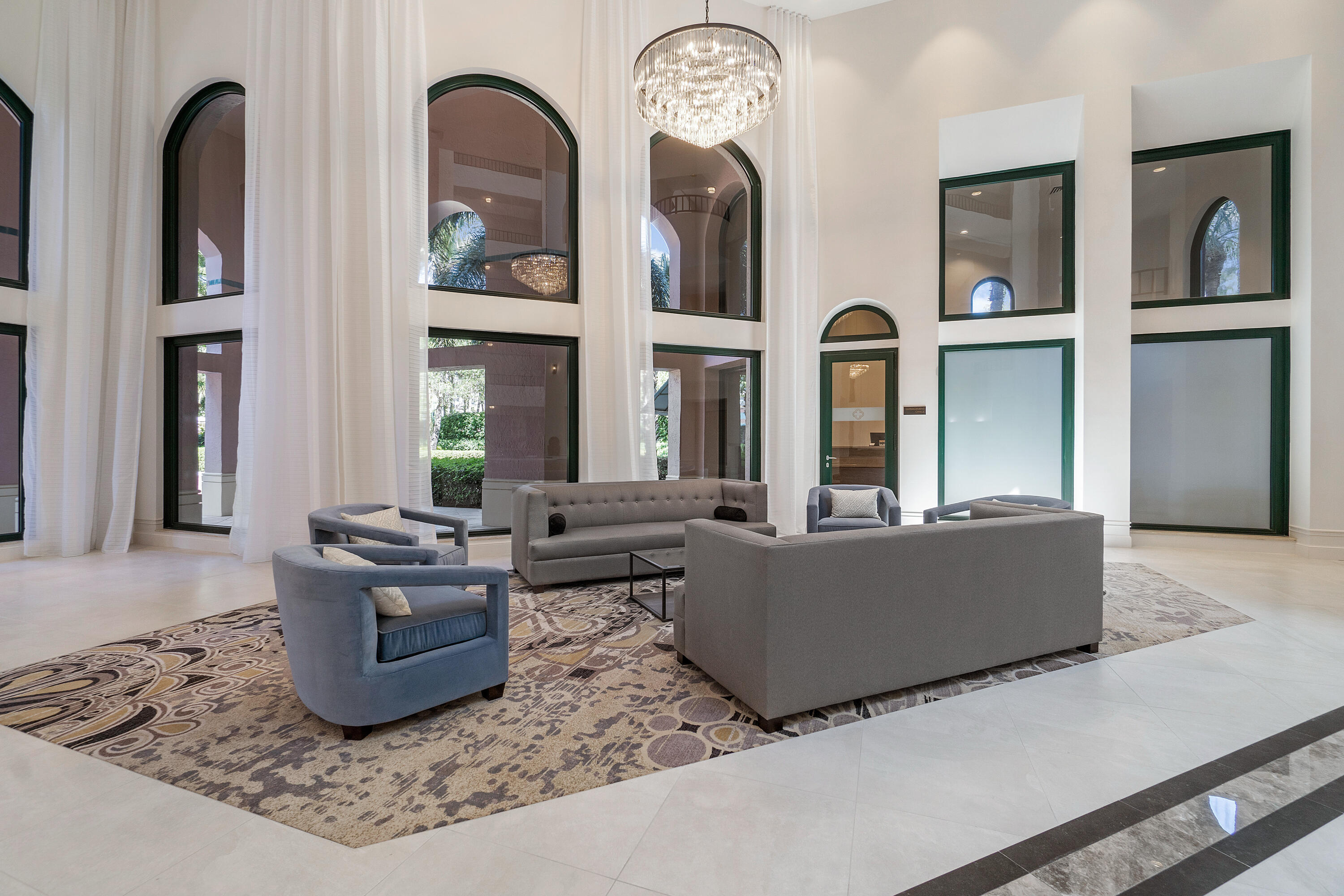 100 Southeast 5th Avenue, Unit 410 Boca Raton, FL 33432 - Photo 5 of 63 a living room with couches chairs and kitchen view