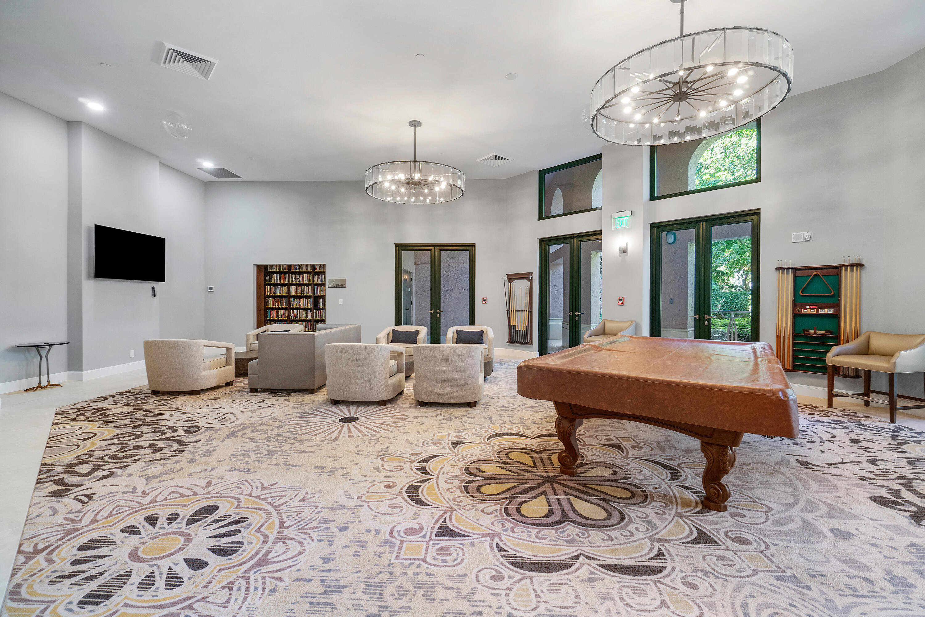 100 Southeast 5th Avenue, Unit 410 Boca Raton, FL 33432 - Photo 52 of 63 a living room with furniture a chandelier and a flat screen tv