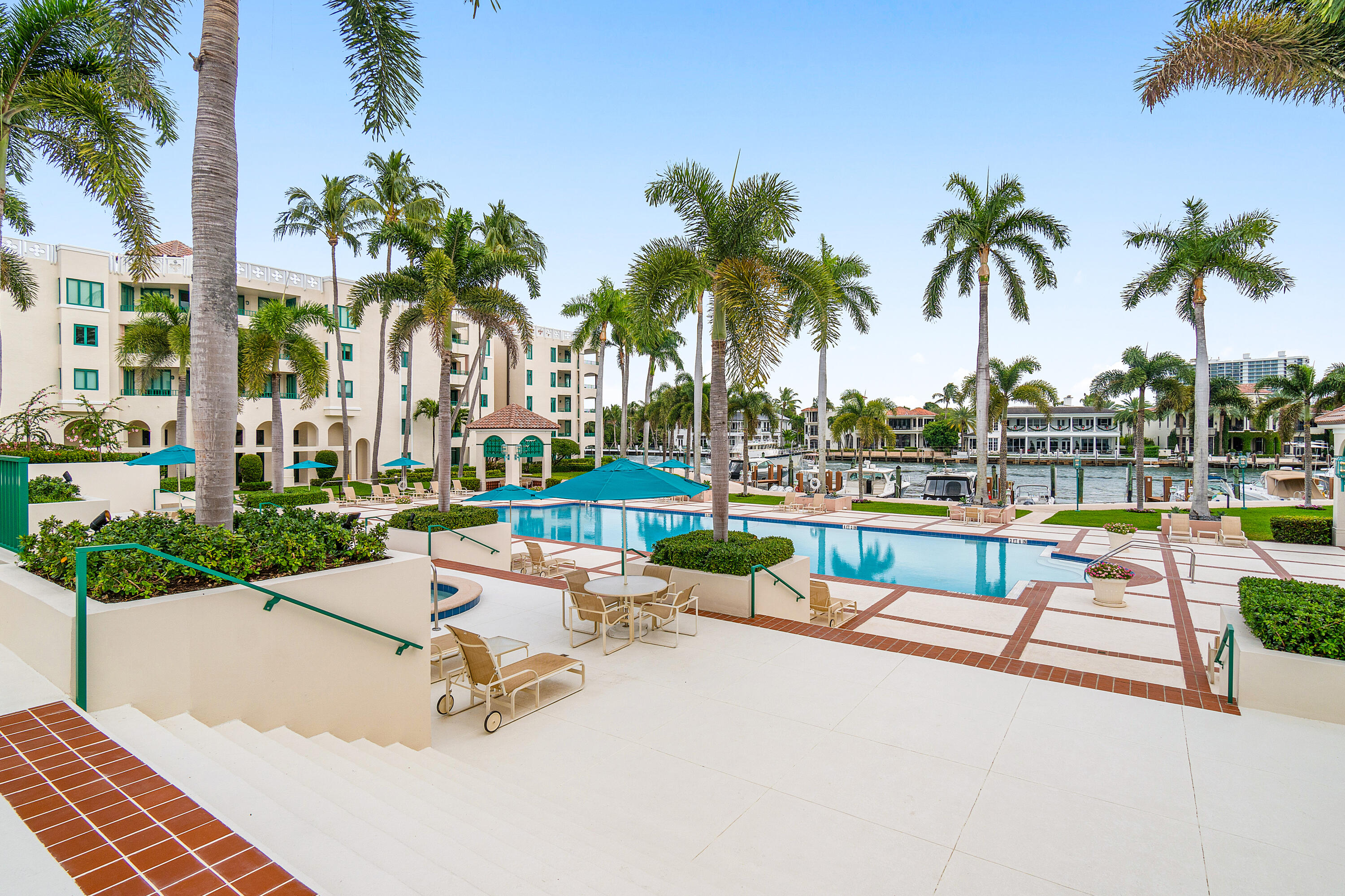 100 Southeast 5th Avenue, Unit 410 Boca Raton, FL 33432 - Photo 57 of 63 a view of swimming pool with outdoor seating and palm tree