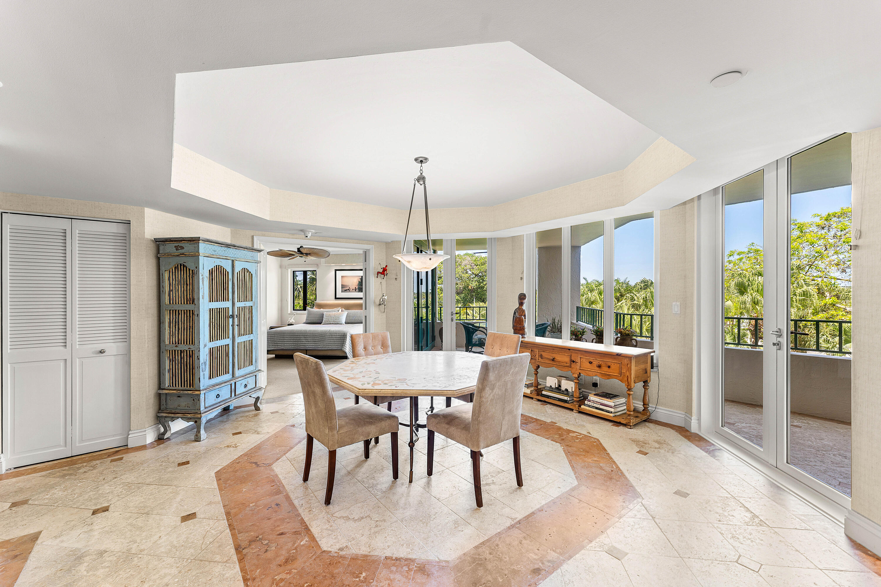 100 Southeast 5th Avenue, Unit 410 Boca Raton, FL 33432 - Photo 10 of 63 a dining room with furniture a chandelier and wooden floor